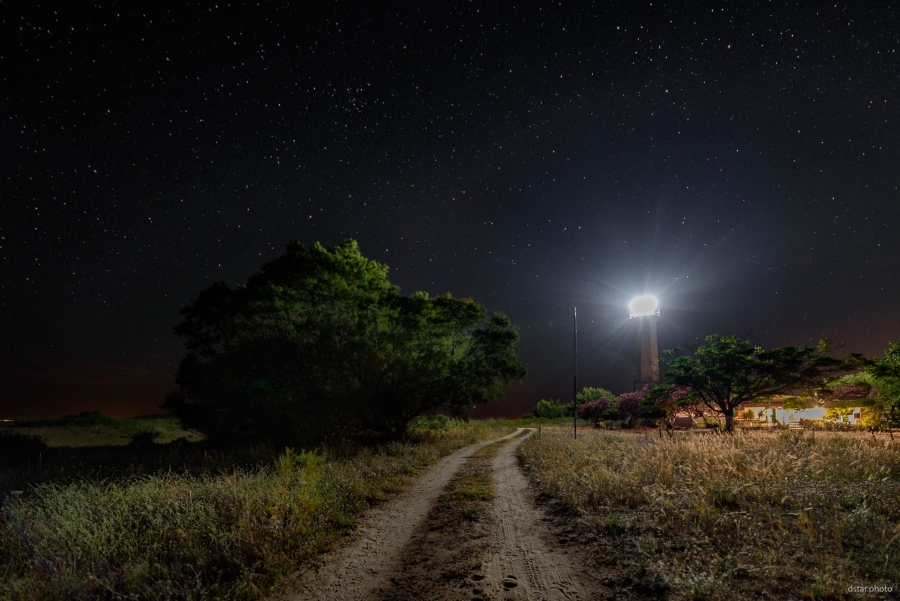 Lighthouse under the starry sky